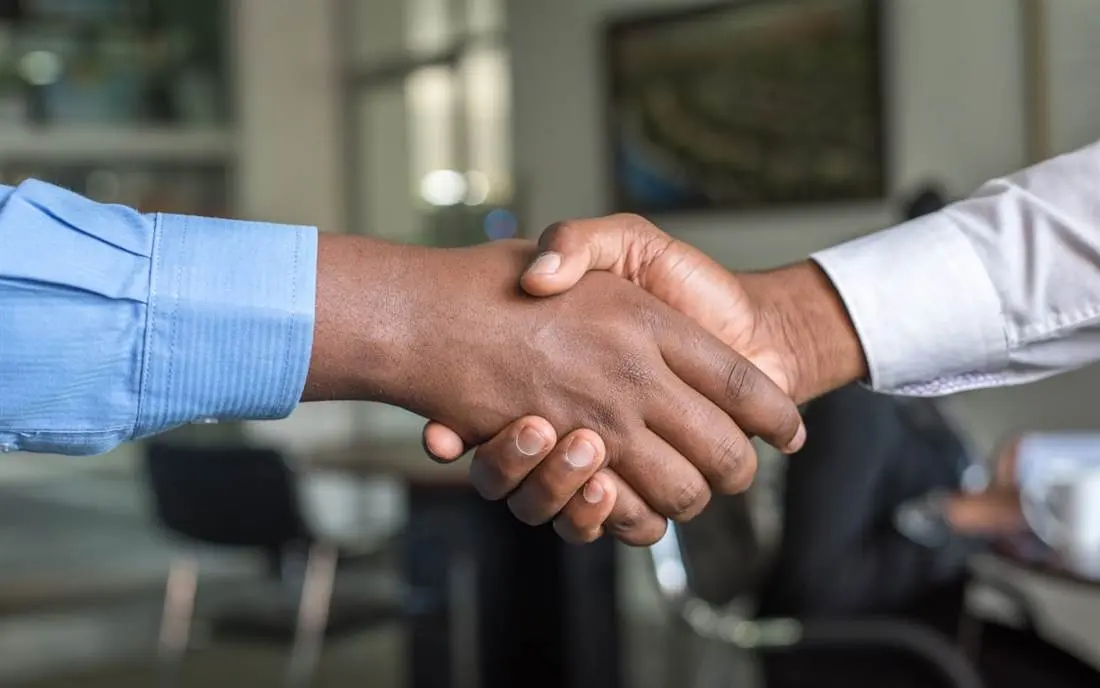 Two people in a professional conversation — starting with a discussion, not a product